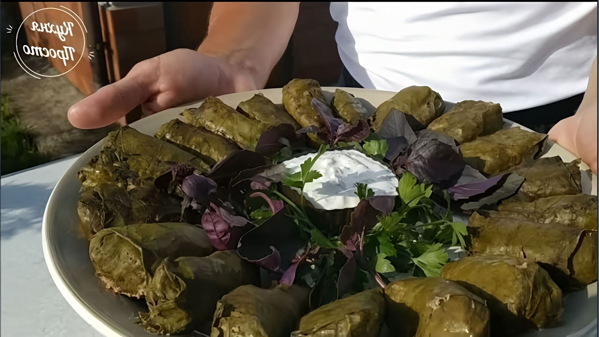 В этом видео демонстрируется процесс приготовления долмы - традиционного блюда из фарша, завернутого в виноградные листья