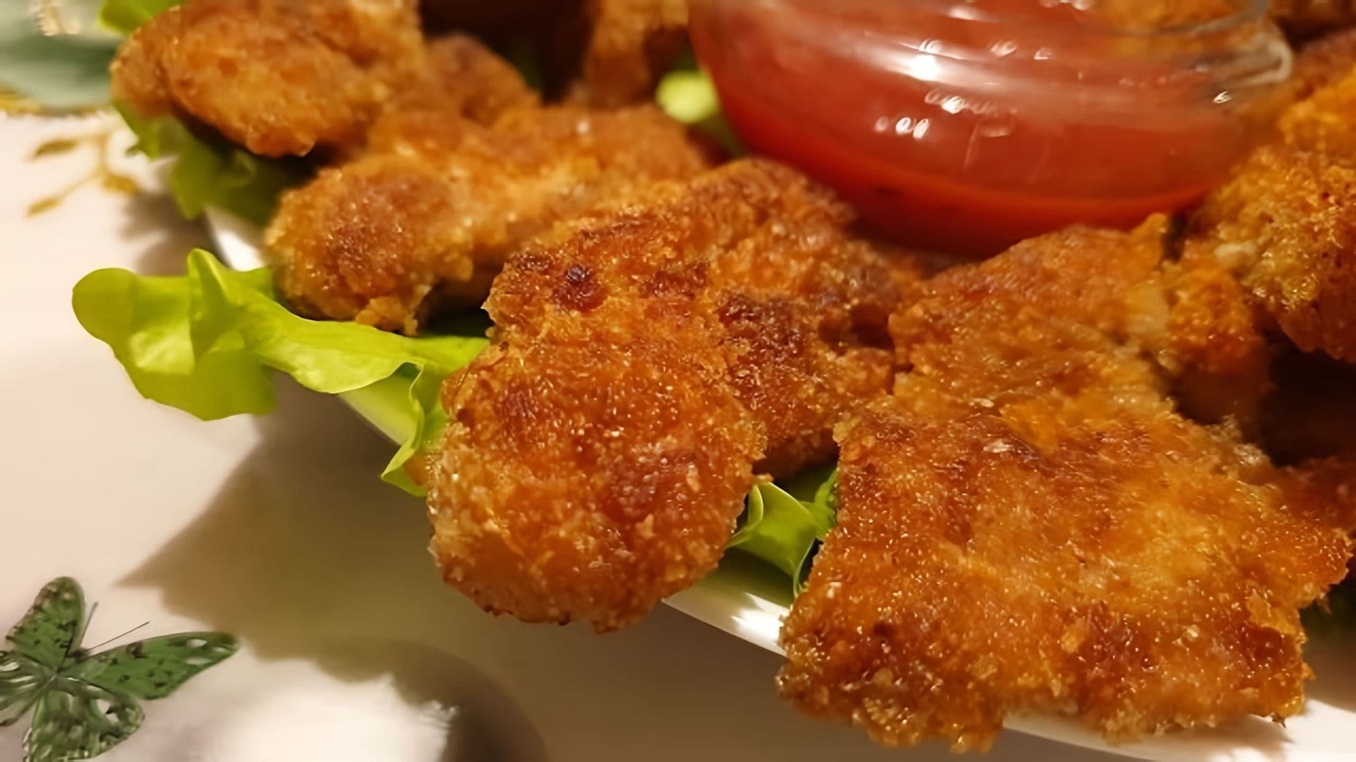 В этом видео демонстрируется процесс приготовления куриных наггетсов, которые по вкусу напоминают те, что подают в KFC