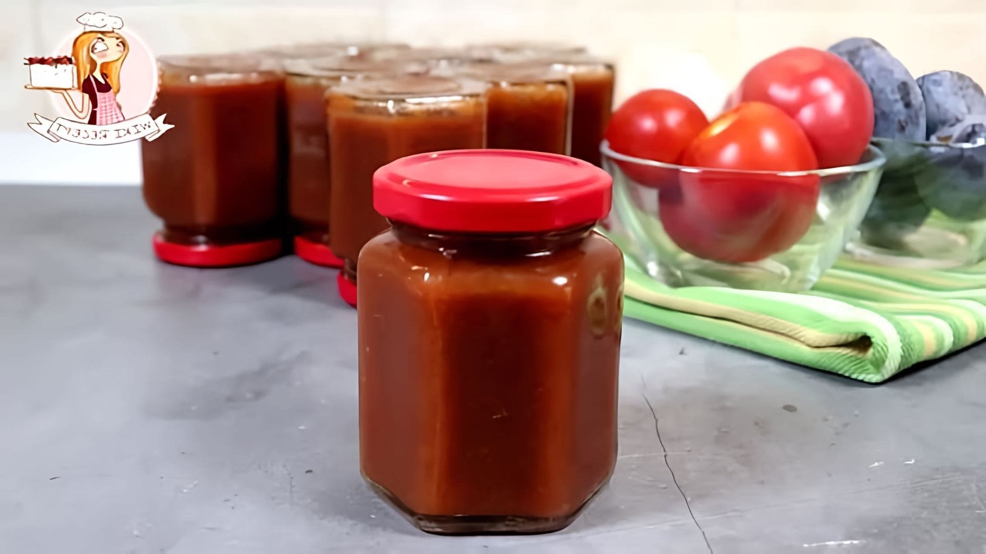 В этом видео демонстрируется процесс приготовления кетчупа из помидоров и слив на зиму