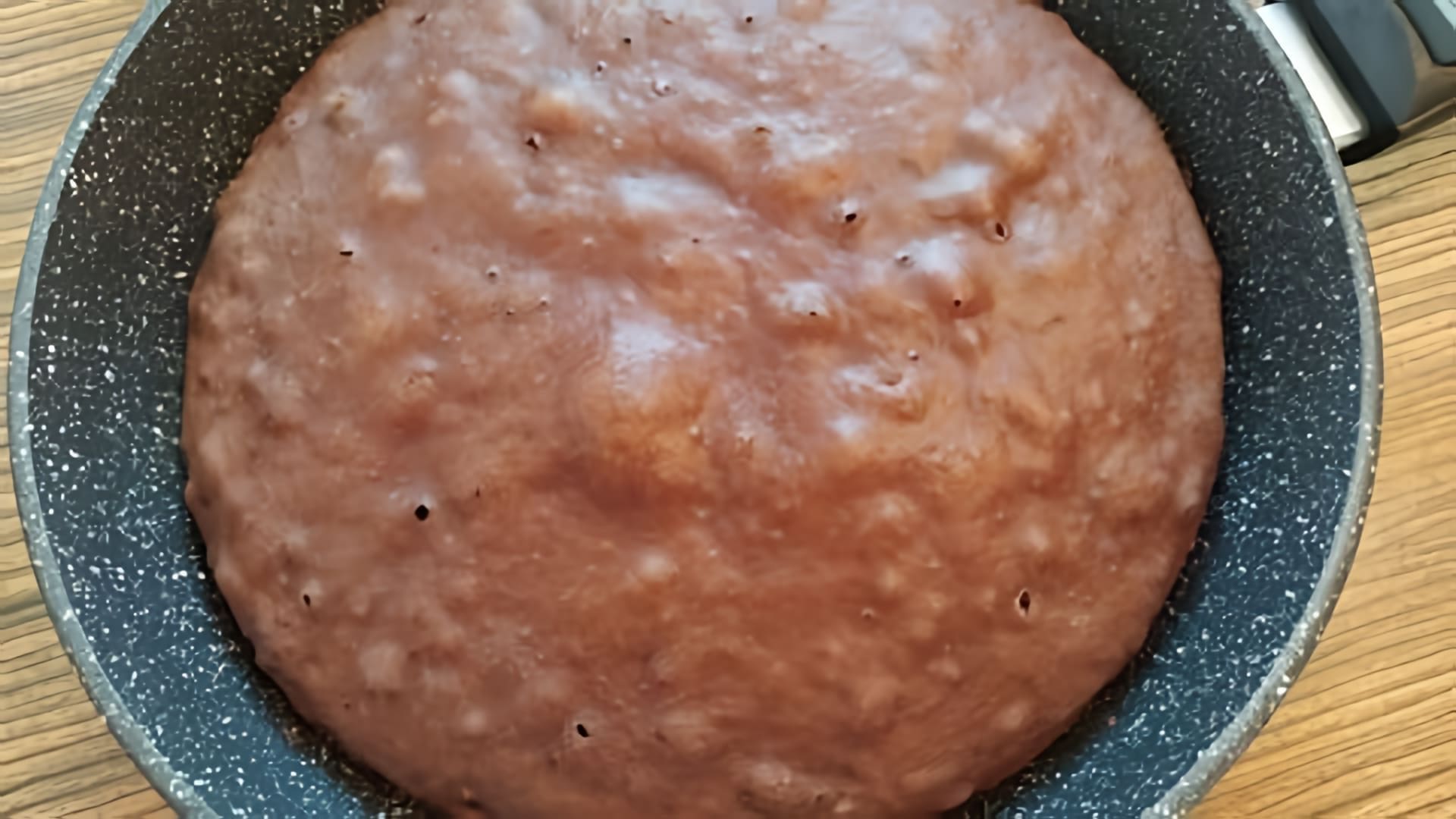 В этом видео демонстрируется процесс приготовления шоколадного пирога на сковороде