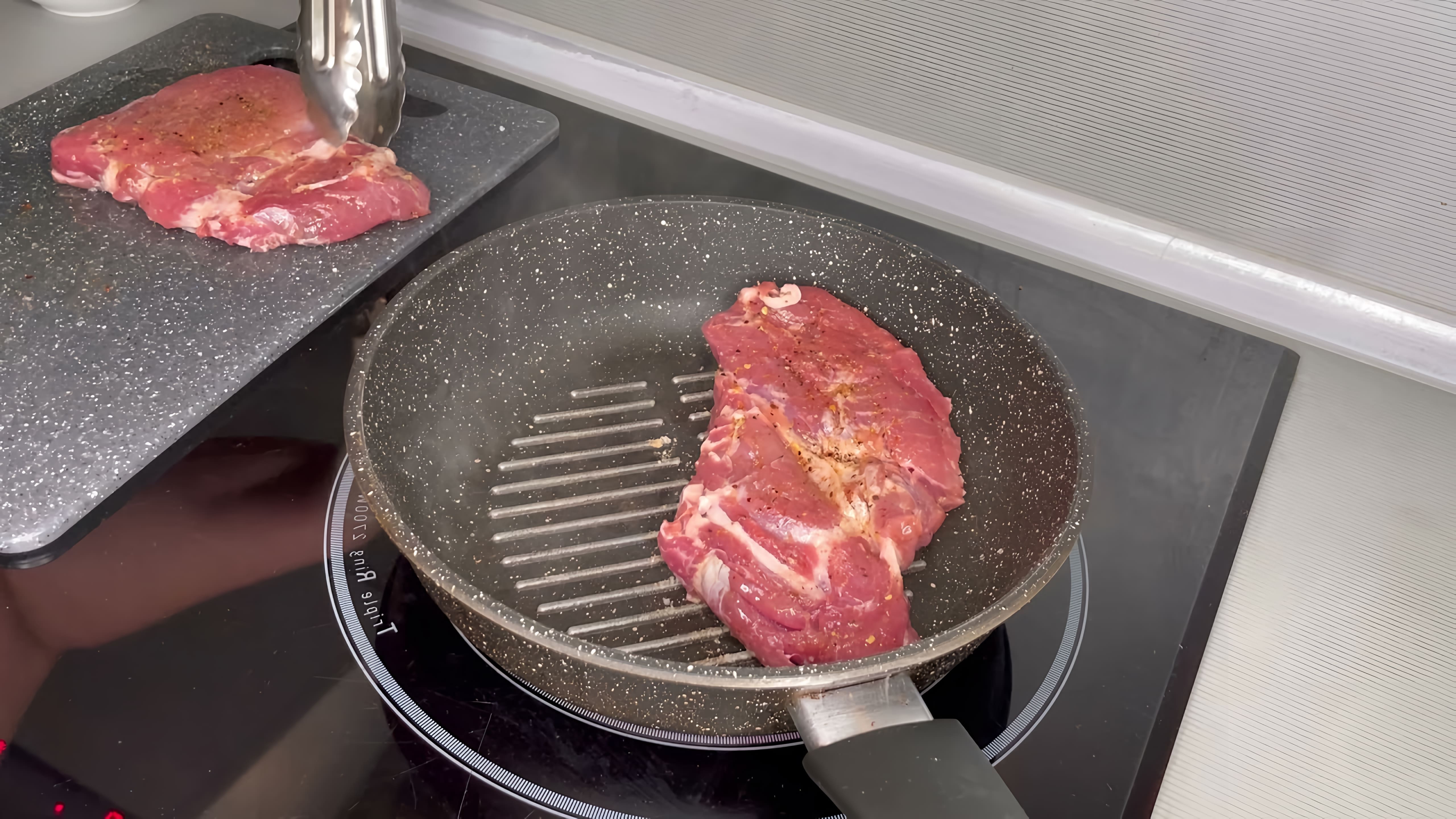 В данном видео демонстрируется процесс приготовления сочного свиного стейка на сковороде-гриль